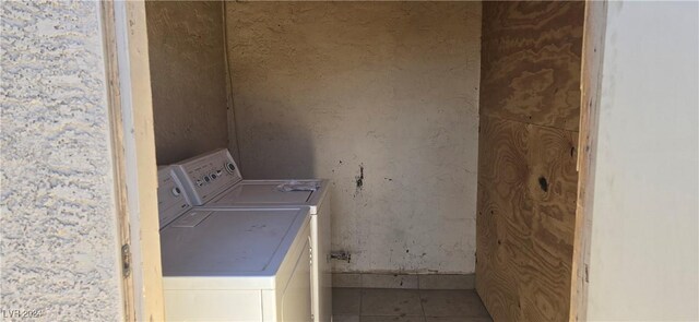 clothes washing area featuring washer and dryer, laundry area, and tile patterned floors