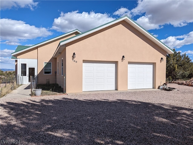 view of side of home featuring a garage