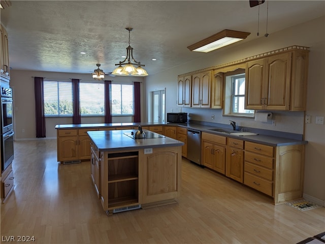 kitchen featuring hanging light fixtures, ceiling fan, a kitchen island, and a wealth of natural light