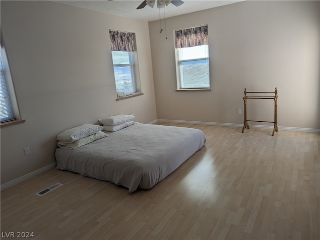 bedroom featuring light hardwood / wood-style floors and ceiling fan