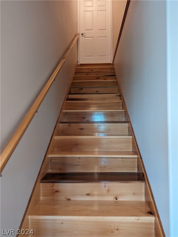 stairway with dark wood-type flooring