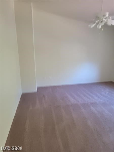 empty room featuring dark colored carpet