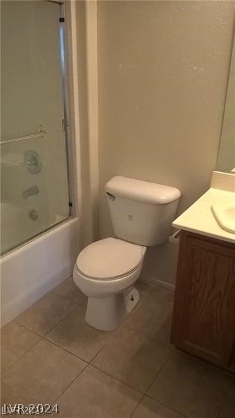 full bathroom featuring enclosed tub / shower combo, vanity, toilet, and tile floors