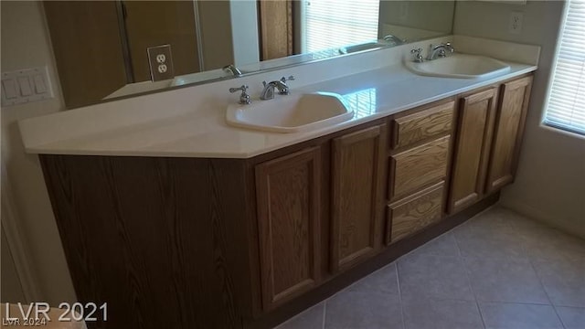 bathroom with dual bowl vanity and tile floors