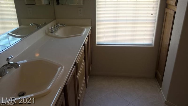 bathroom featuring a washtub, oversized vanity, tile flooring, and double sink