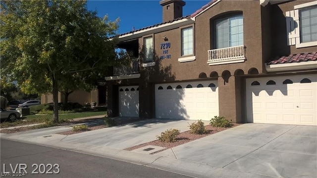 view of front of house featuring a balcony and a garage