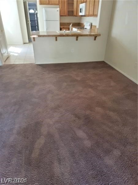 unfurnished dining area featuring light colored carpet