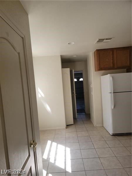 hallway featuring light tile floors