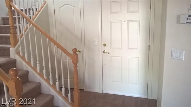 staircase with dark carpet