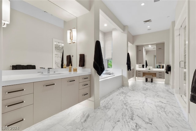 bathroom with a tub, tile flooring, and vanity