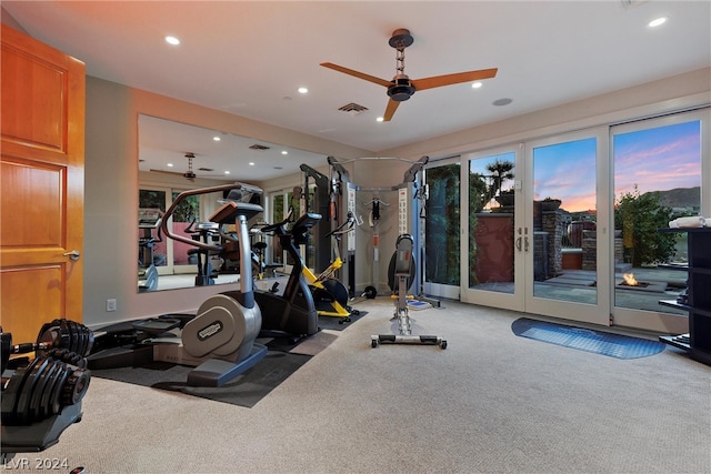 exercise room featuring ceiling fan, french doors, and carpet flooring