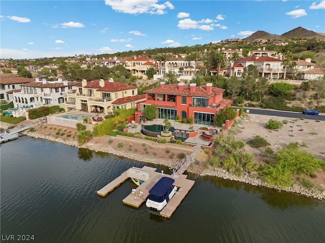 drone / aerial view featuring a water and mountain view