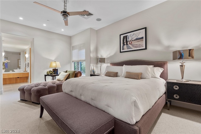 carpeted bedroom featuring ensuite bathroom and ceiling fan