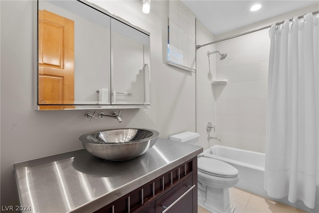 full bathroom with tile floors, shower / tub combo with curtain, vanity, and toilet