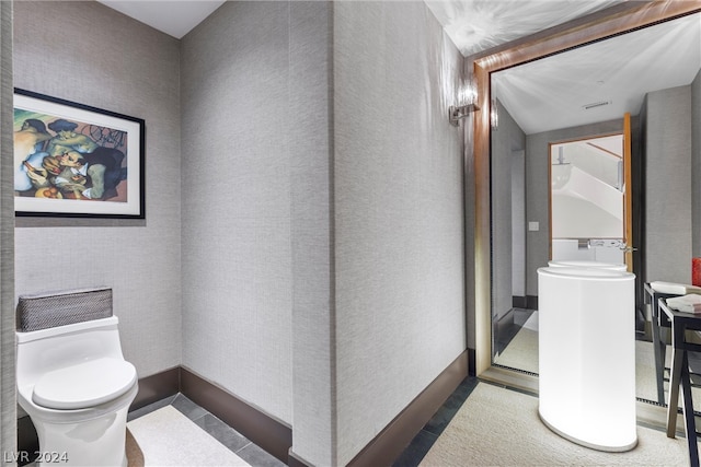 bathroom with tile floors and toilet