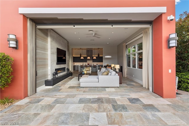 exterior space with an outdoor fireplace and light tile floors