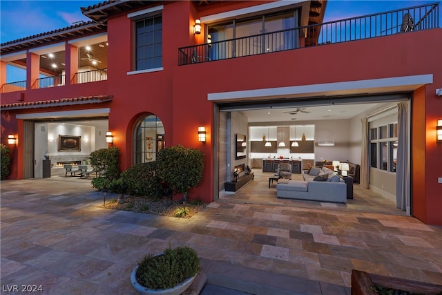 exterior space featuring a patio area, an outdoor living space, and a balcony