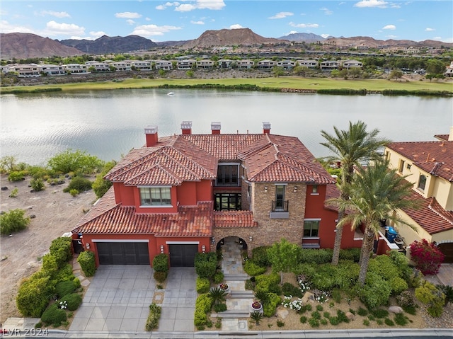 exterior space with a water and mountain view