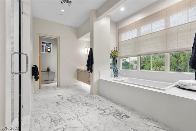 bathroom with a bathtub and tile floors