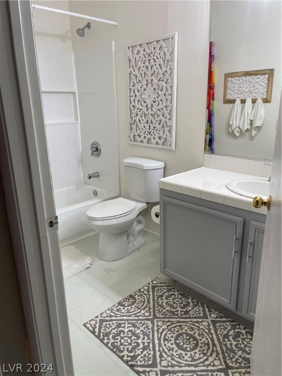 full bathroom featuring shower / bathtub combination, vanity, tile patterned floors, and toilet