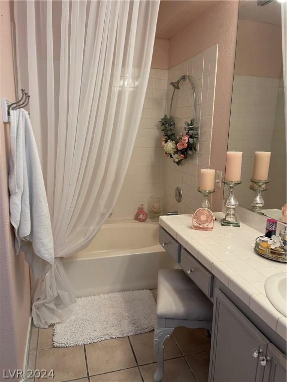 bathroom with tile patterned flooring, shower / bath combination with curtain, and vanity