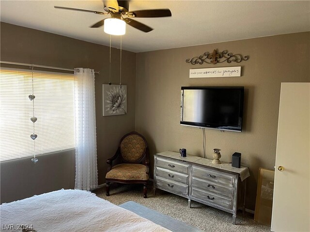 bedroom with light carpet and ceiling fan