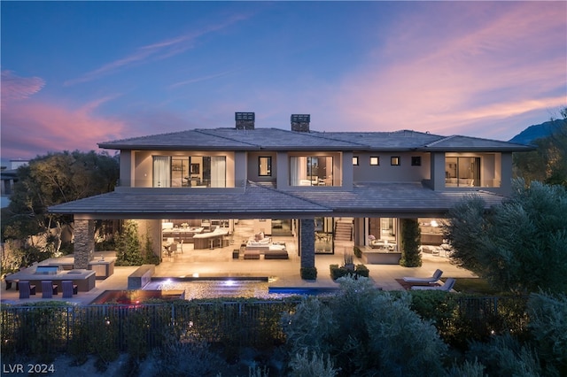 view of front facade featuring a patio area and a swimming pool