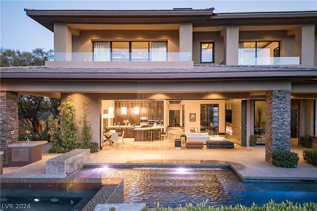 back of house with a patio and an outdoor living space