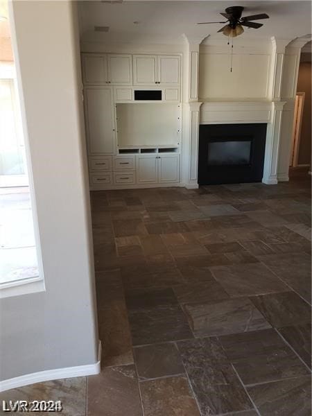 unfurnished living room featuring ceiling fan