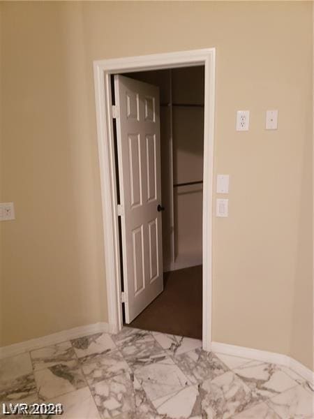 unfurnished bedroom featuring a spacious closet and a closet