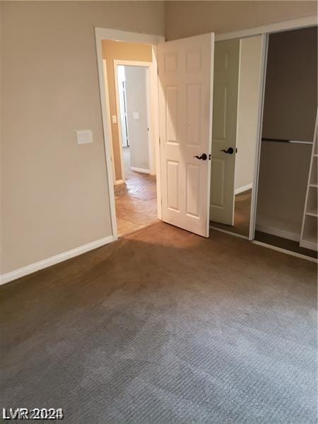 unfurnished bedroom featuring carpet and a closet