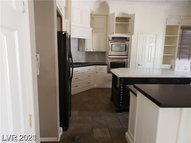 kitchen featuring stainless steel appliances, tasteful backsplash, and ornamental molding