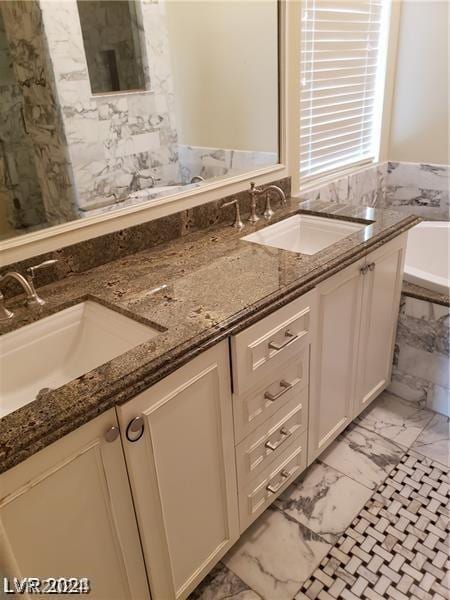 bathroom with vanity and a bath