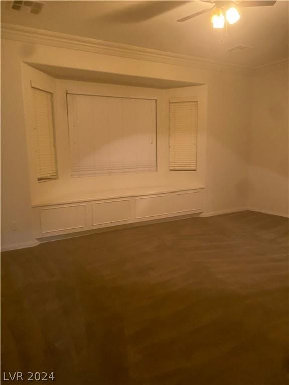 unfurnished room featuring ceiling fan, ornamental molding, and dark hardwood / wood-style floors