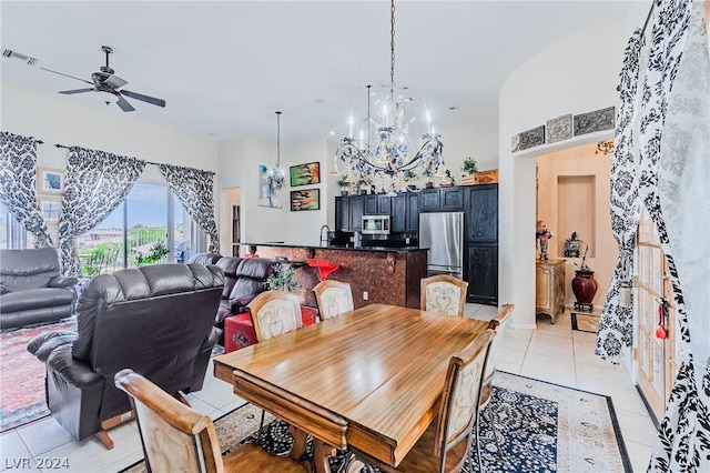 dining room with ceiling fan with notable chandelier, visible vents, and light tile patterned floors