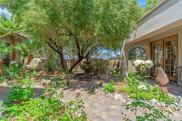 view of yard with a patio, french doors, and a fenced backyard