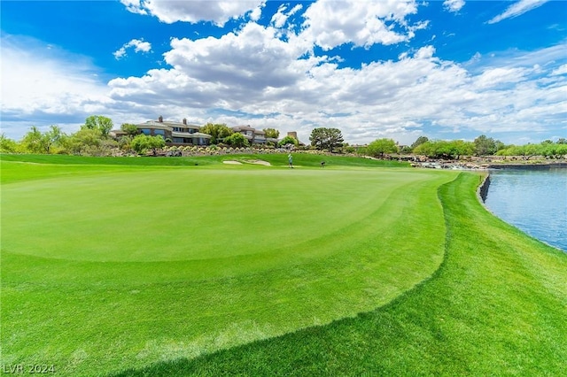 surrounding community featuring view of golf course and a water view