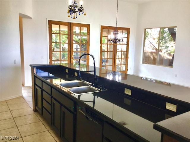 kitchen with dark countertops, pendant lighting, a notable chandelier, and french doors