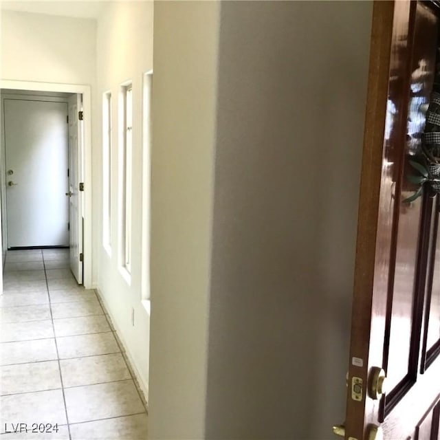 hall featuring light tile patterned flooring