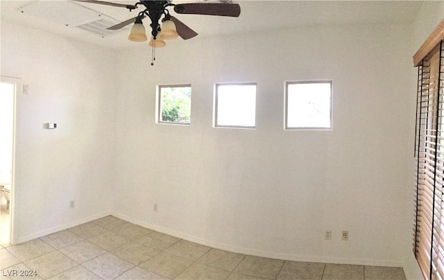 spare room featuring ceiling fan and baseboards