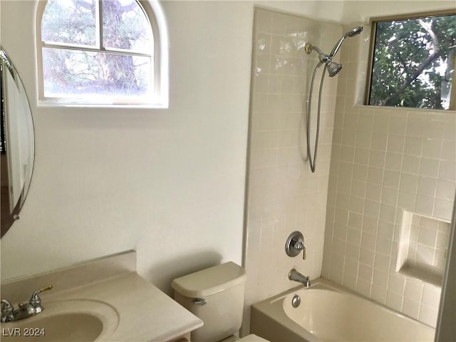 bathroom featuring toilet, shower / tub combination, and vanity