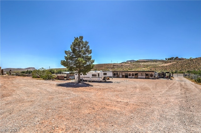 view of yard featuring a mountain view and a rural view