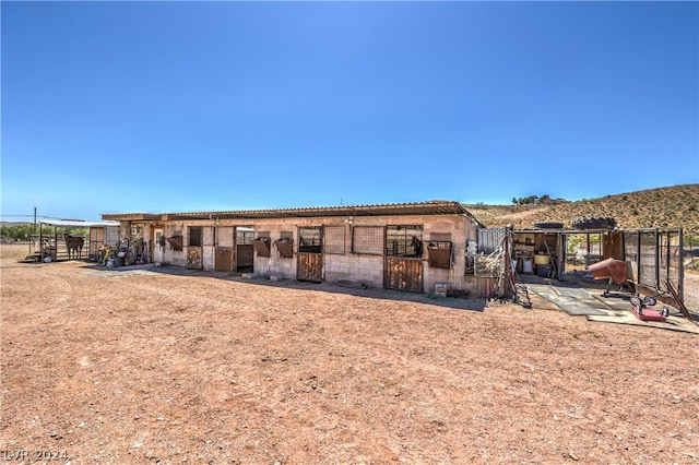 back of property featuring an outdoor structure