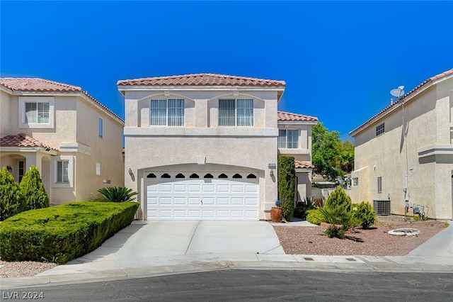 view of front of property with a garage and central AC unit