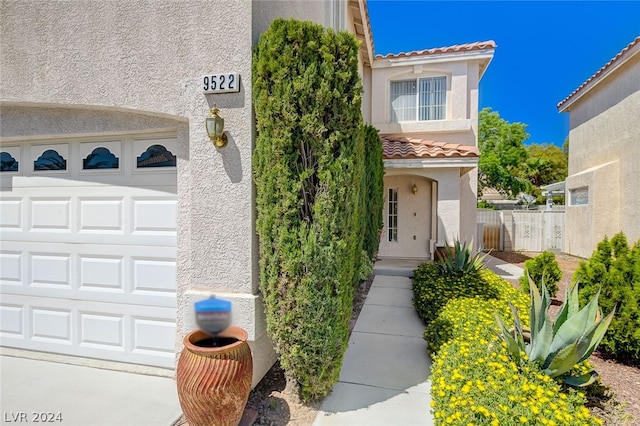 view of exterior entry with a garage