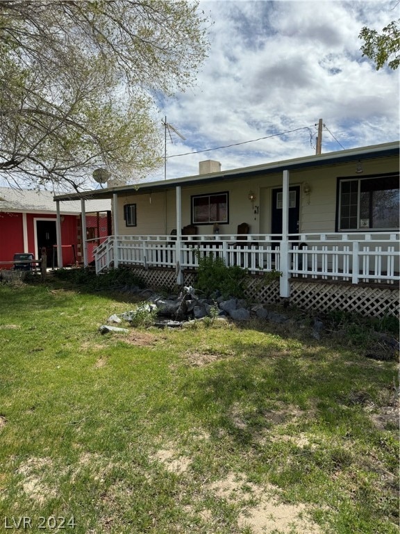 back of property featuring a yard