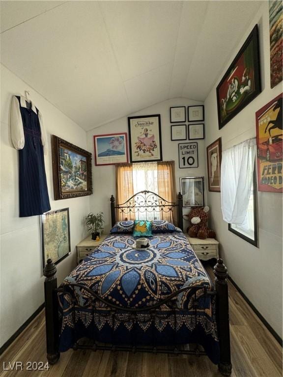 bedroom with lofted ceiling and wood-type flooring