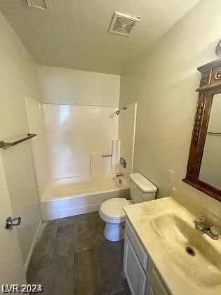 full bathroom with bathtub / shower combination, large vanity, tile floors, and toilet