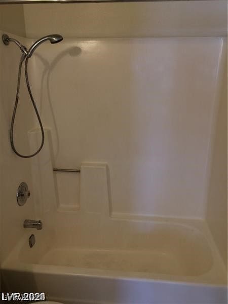 bathroom with washtub / shower combination