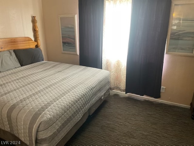 bedroom featuring dark carpet